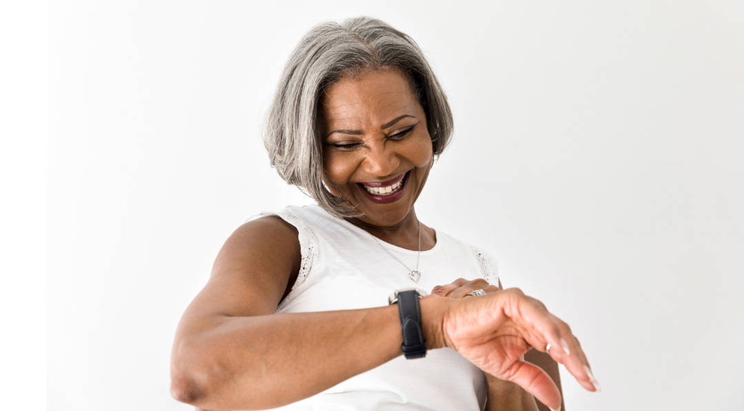 Lady smiling looking at a wearable